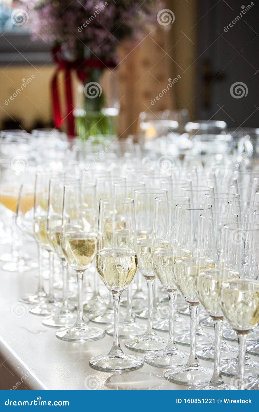 Vertical Shallow Focused Shot of Champagne Glasses with Champagne Inside on a Festive Table