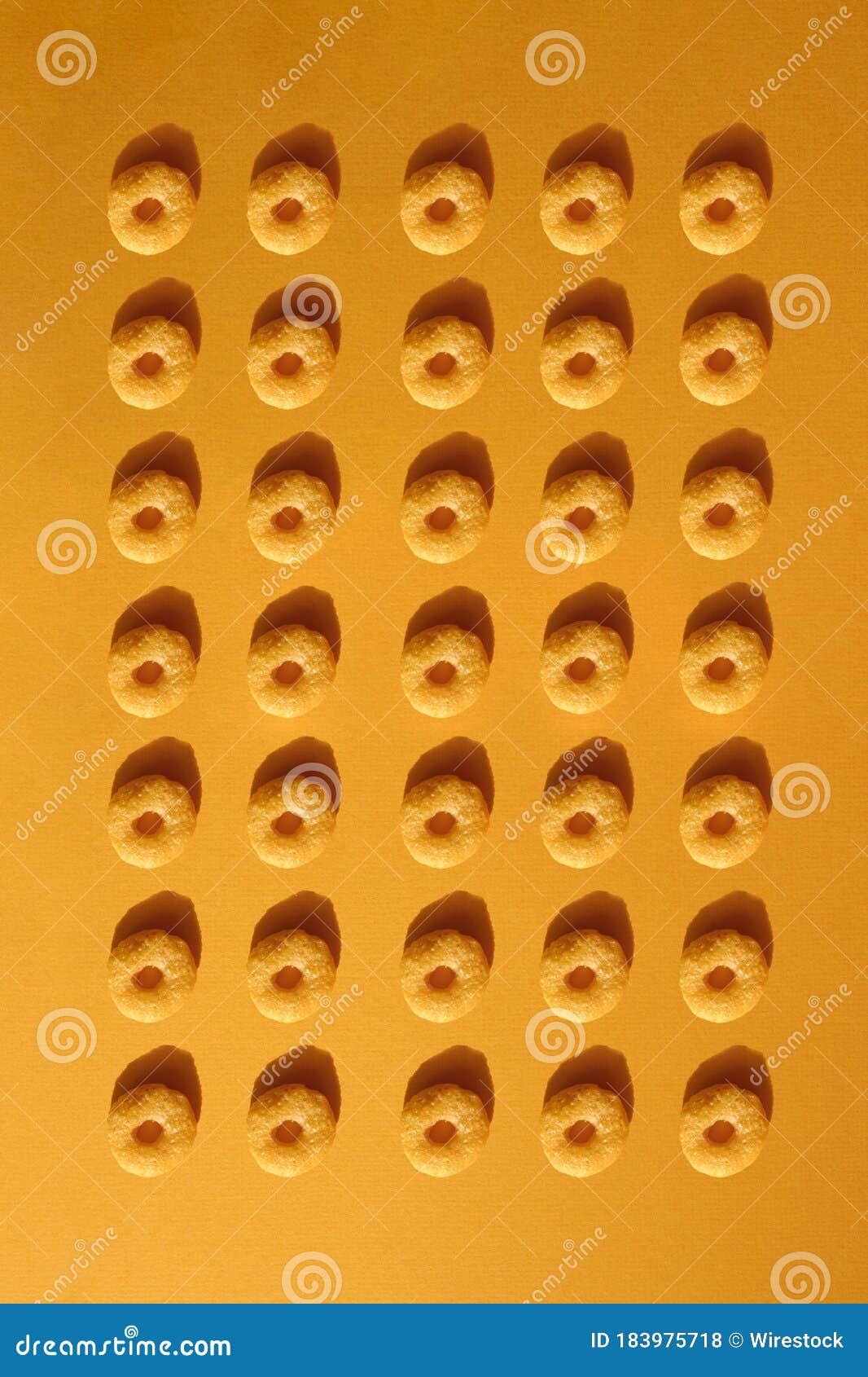 Vertical Shot of Ancient Yellow Glass Beads on Yellow Background Displayed in a Museum Stock