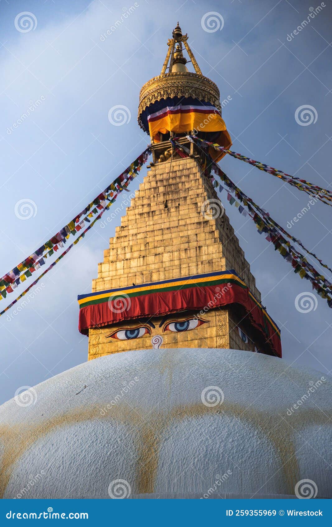 vertical shot of the boudhanath stupa temple in katmandu, nepal with a cloudy sky in the background