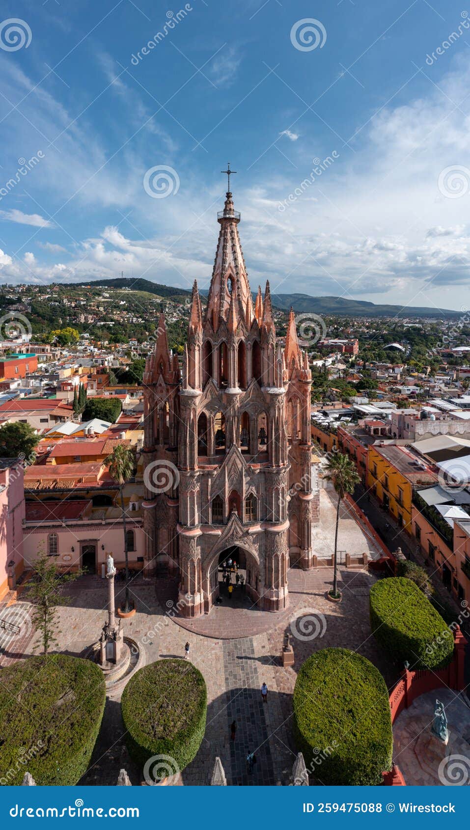 vertical shot of the church of st. michael (parroquia de san miguel arcangel) against a blue sky