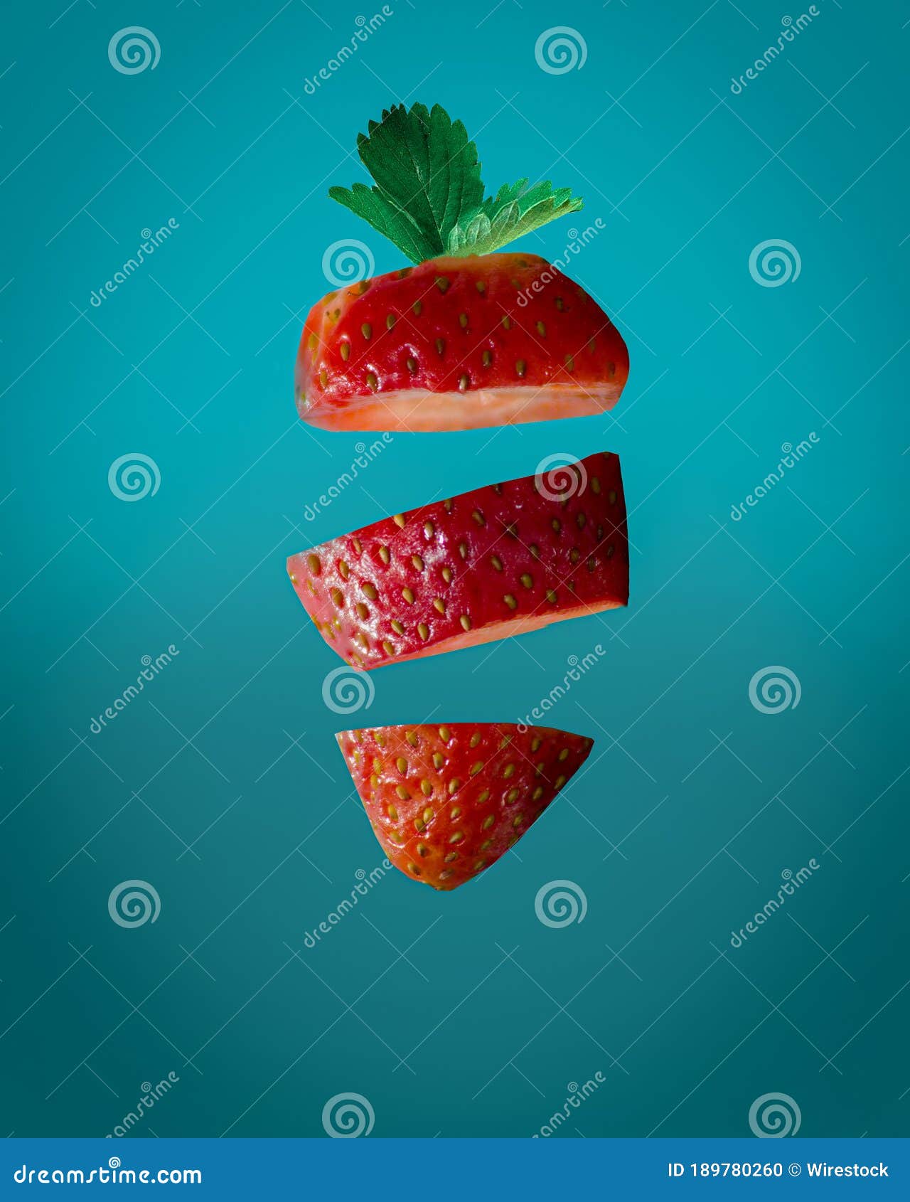 Vertical Shot of Cut Strawberry on an Aquatic Blue Background Stock