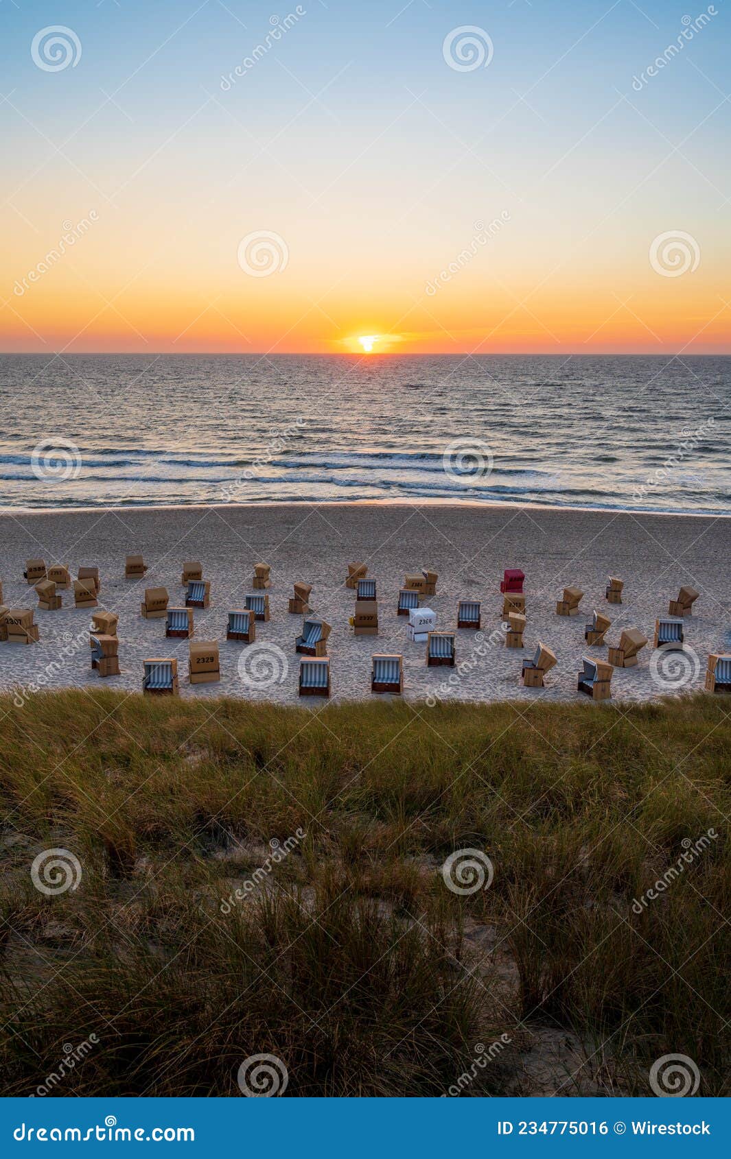 Vertical Shot of the Different Couches on a Seashore at Sunset. Sylt