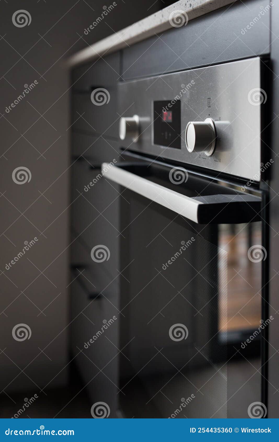 Vertical Shot of an Electric Oven with Control Knobs Stock Photo