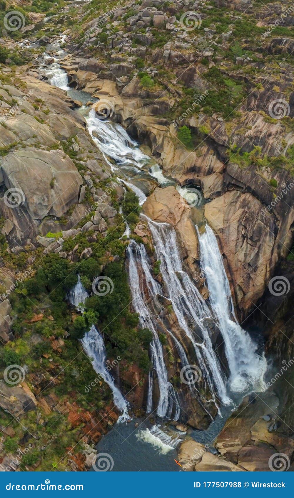 vertical shot of the ezaro waterfall in galicia, spain