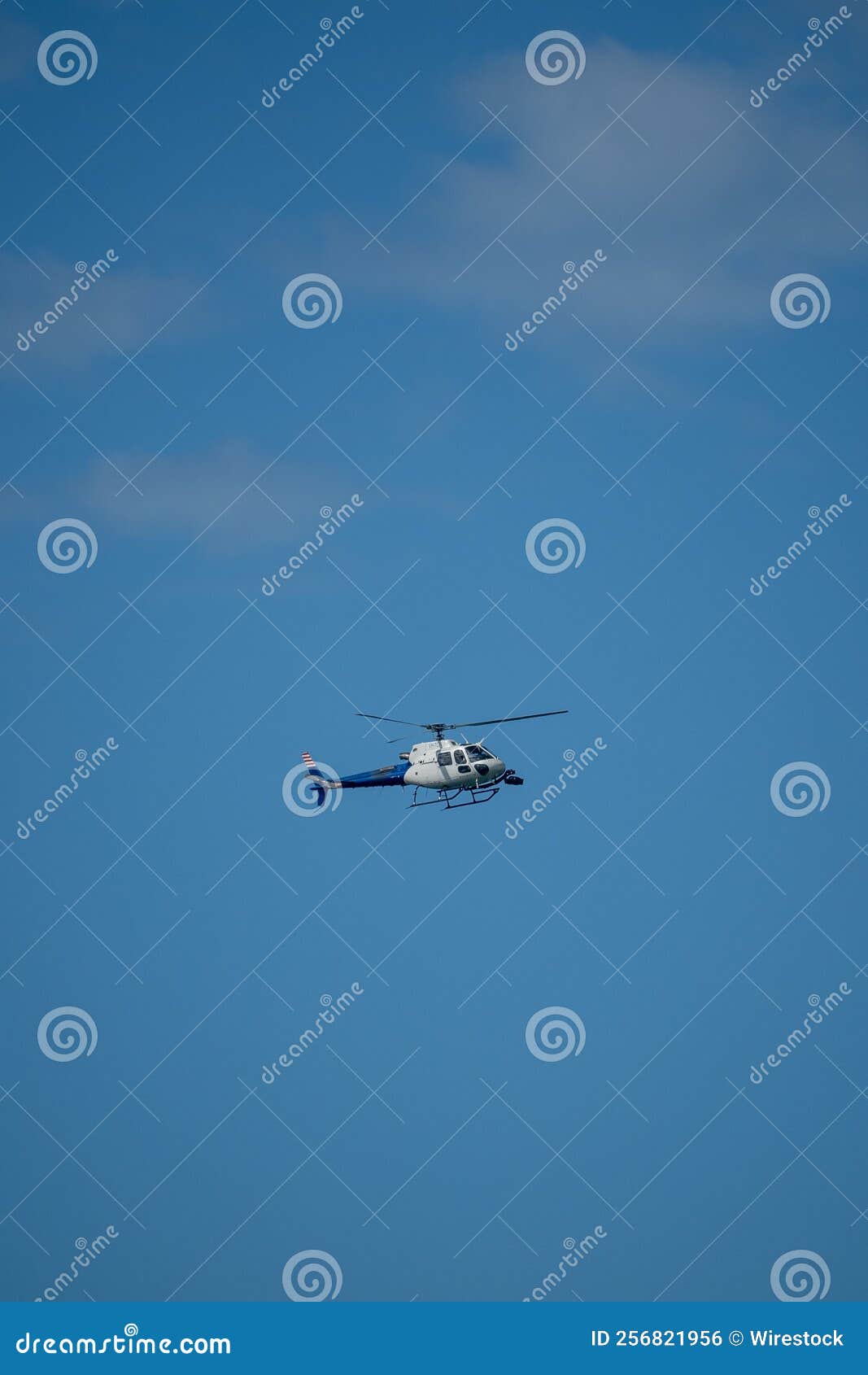 Vertical Shot of a Helicopter Flying in the Blue Sky. Editorial Photo