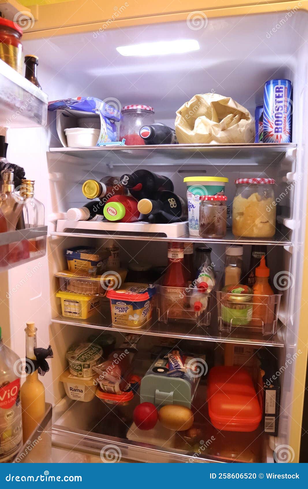 Vertical Shot of the Inside of a Fridge with Typical German Products