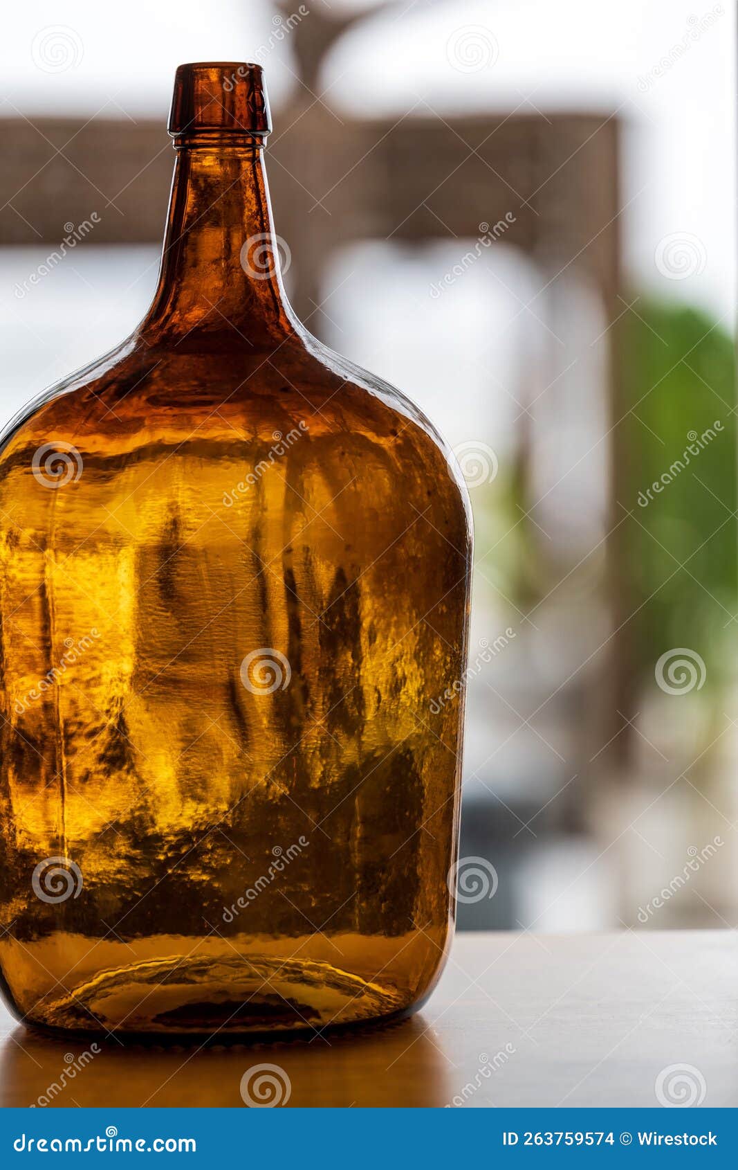 Vertical Shot of a Large Amber Glass Bottle with a Thin Neck Stock