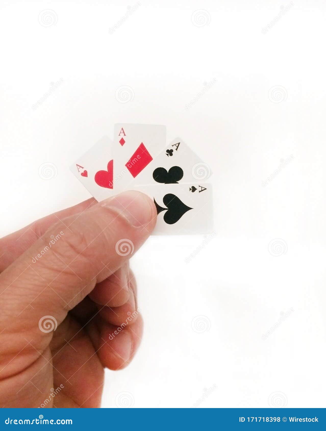 Vertical Shot of a Man Holding a Very Small Deck of Cards Behind a