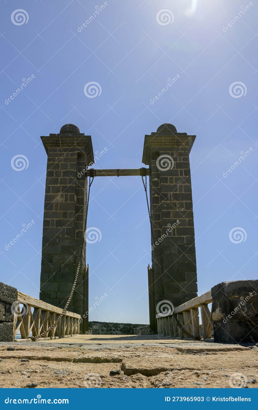 vertical shot of puente de las bolas, a bridge that leads to san gabriel castle in arrecife