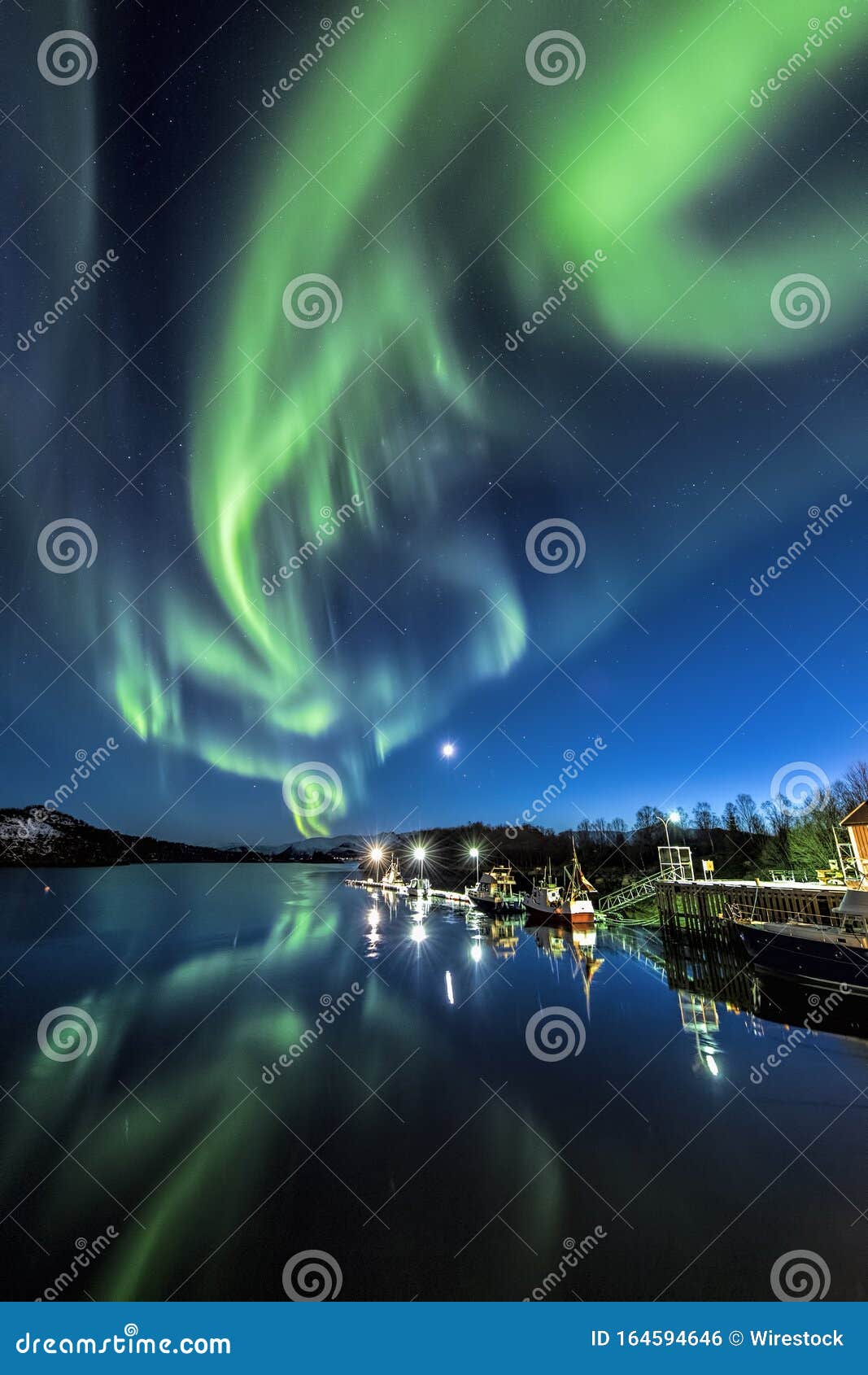 Vertical Shot of the Reflection of the Colorful Northern Lights in the