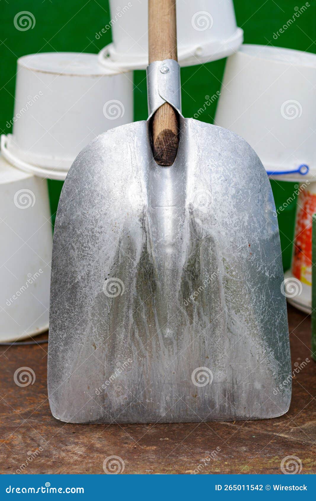 Vertical Shot of a Shovel with Stacked White Containers in the Background Stock Photo Image of