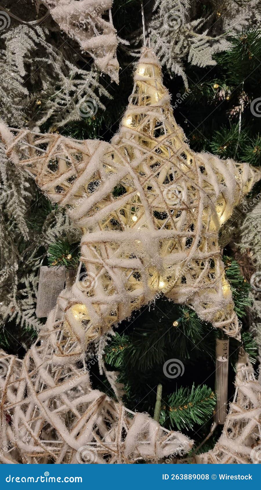 vertical shot of star-d chrismas ornaments on a tree