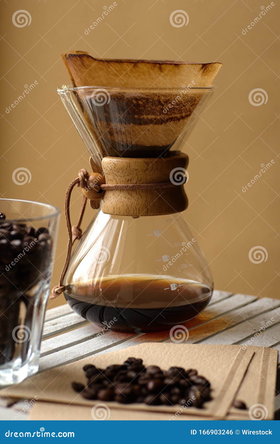 Vertical Shot of a Steaming Coffee Filter and a Glass Cup Filled with