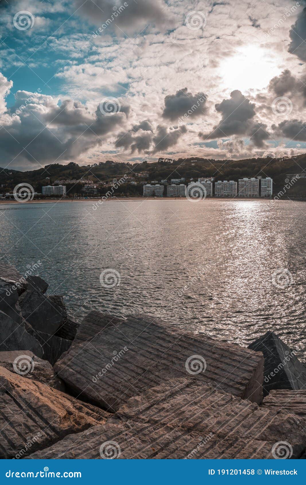 vertical shot of the town of fuenterrabia on the body of the sea in the basque country, spain