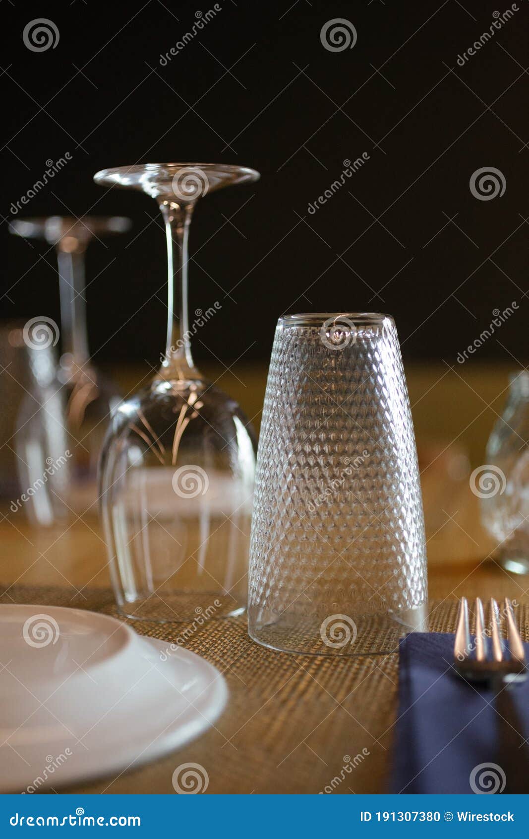 Vertical selective focus shot of glass water pitchers and empty upside-down  glasses on a tray Stock Photo by wirestock