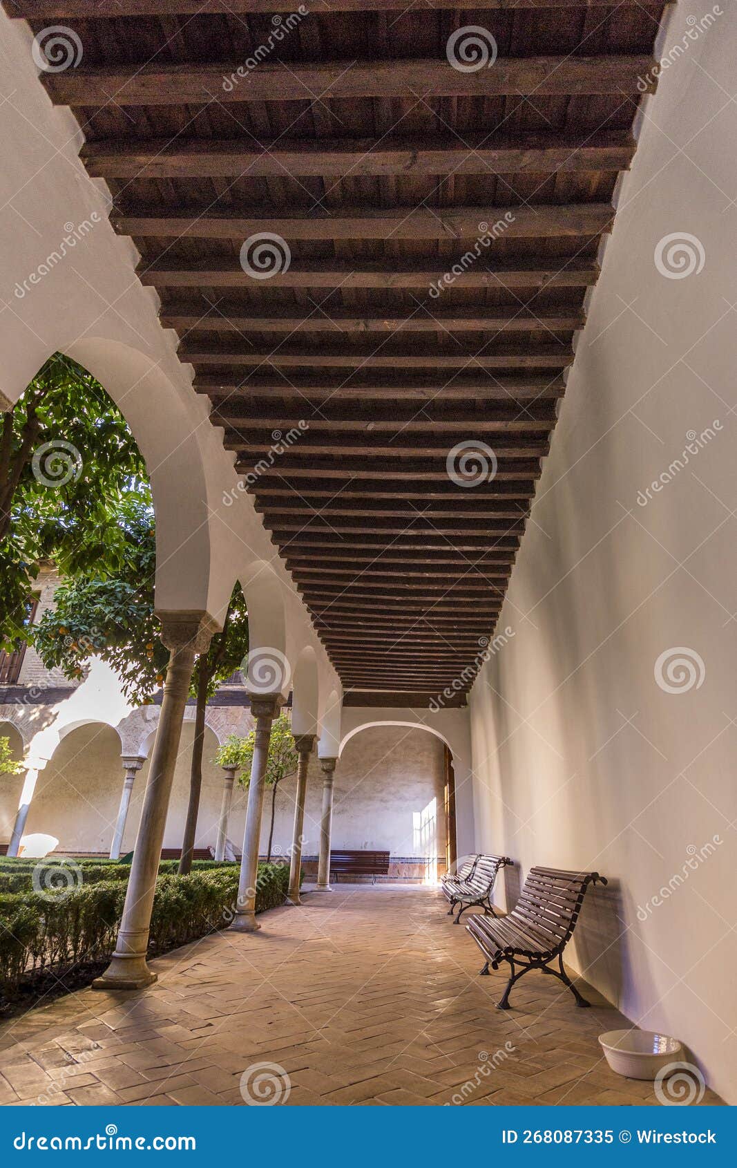 vertical shot of wooden benches in espacio santa clara in seville, spain