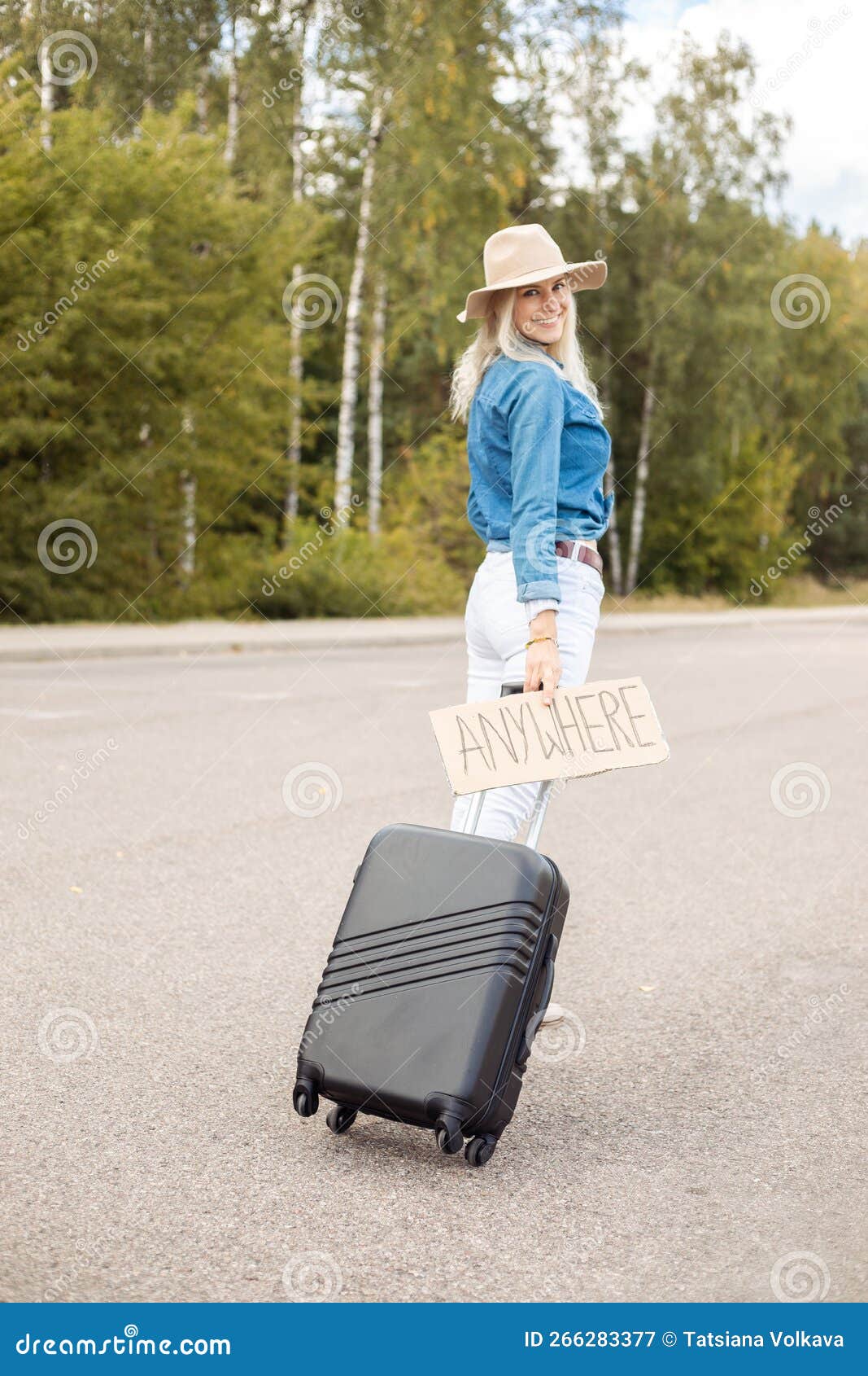 Vertical Smiling Blond Woman Hitchhiker With Carton Plate Anywhere Carrying Roll Aboard Suitcase