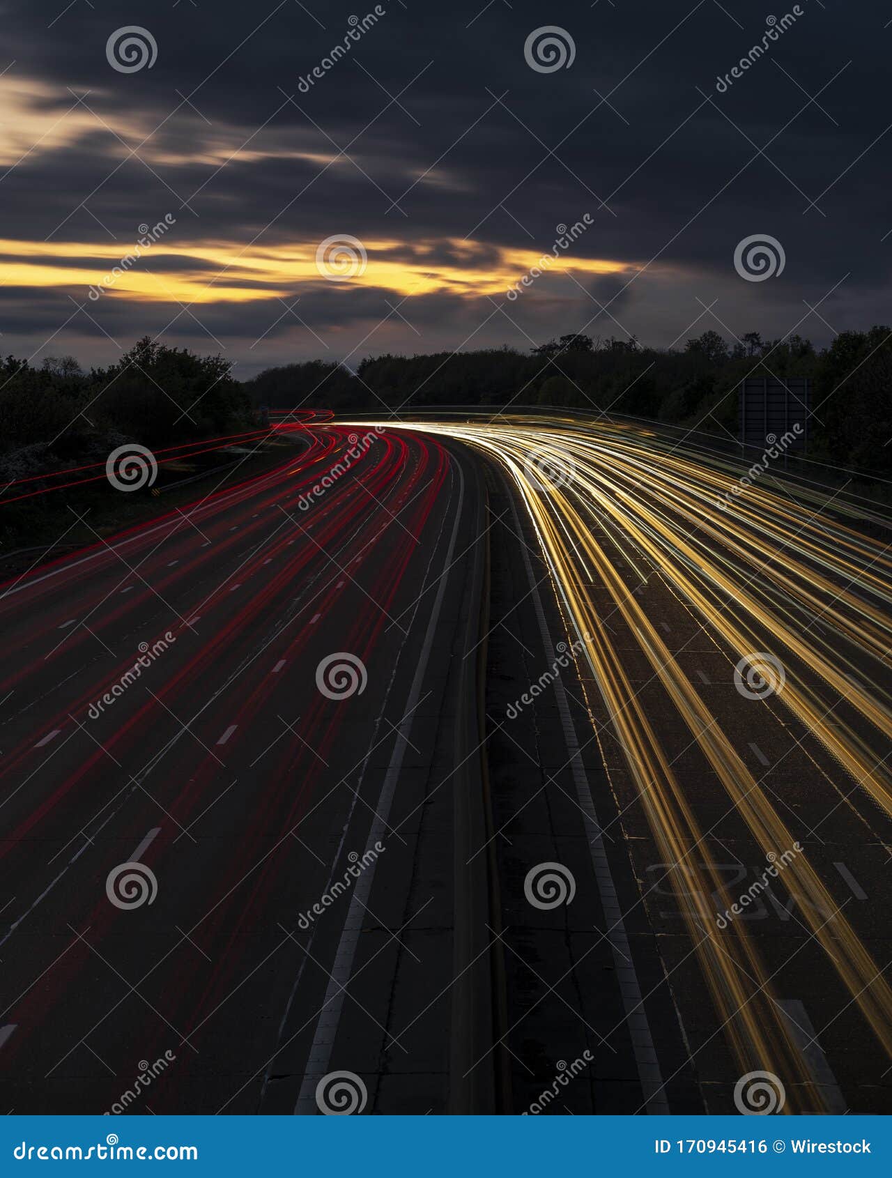 Vertical Timelapse Shot of Car Lights at Night Time Under a Sunset Sky