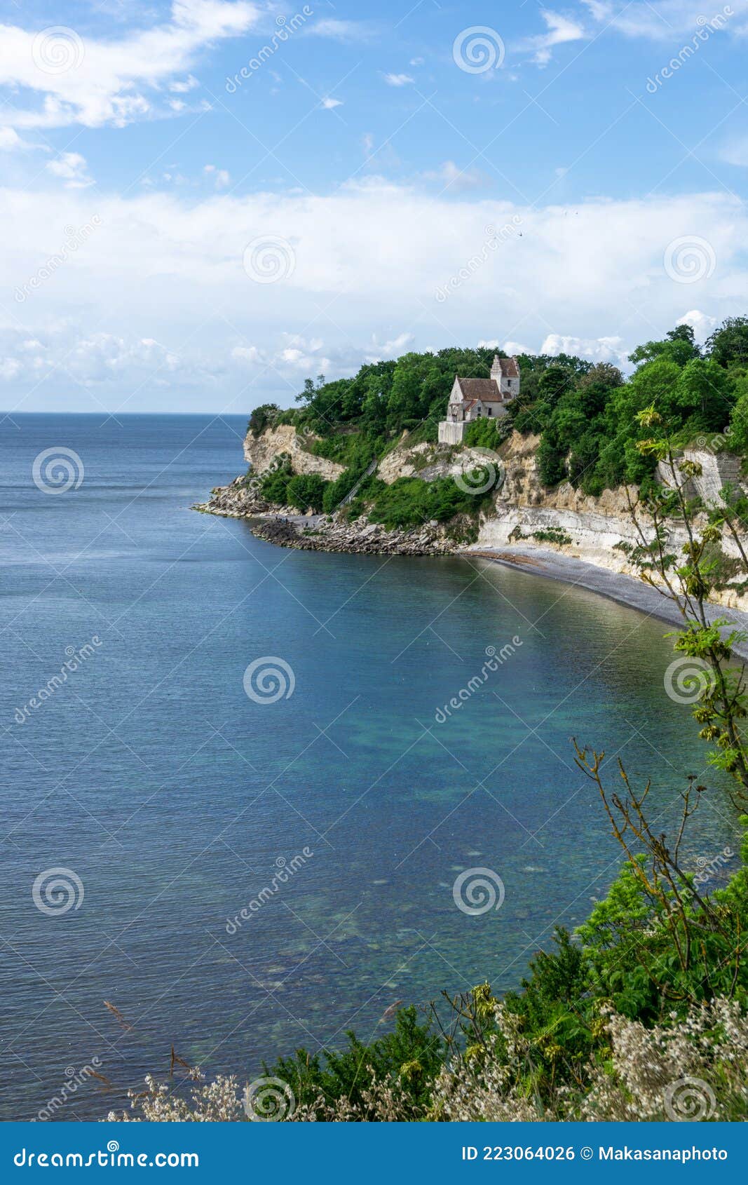 vertical view of the church at hojerup on top of the white chalkstone cliffs of stevns klint