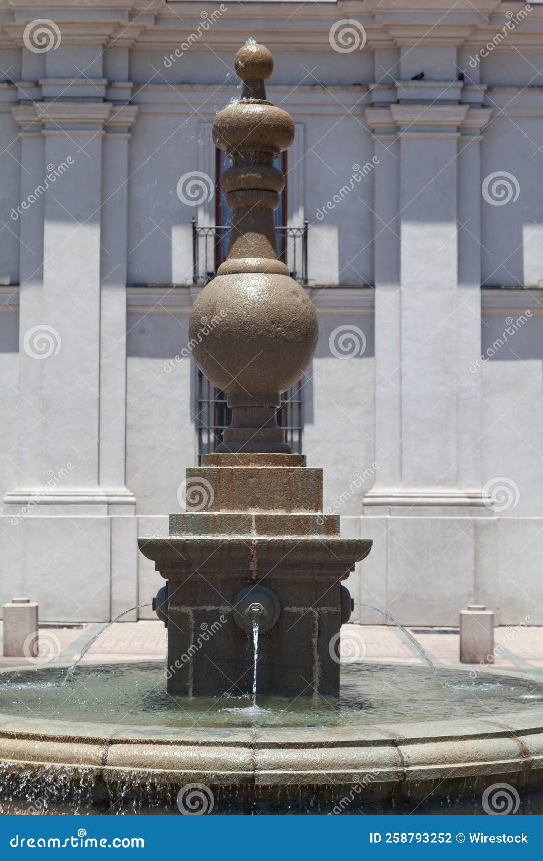 vertical view of a fountain in front of the la moneda palace in santiago, chile
