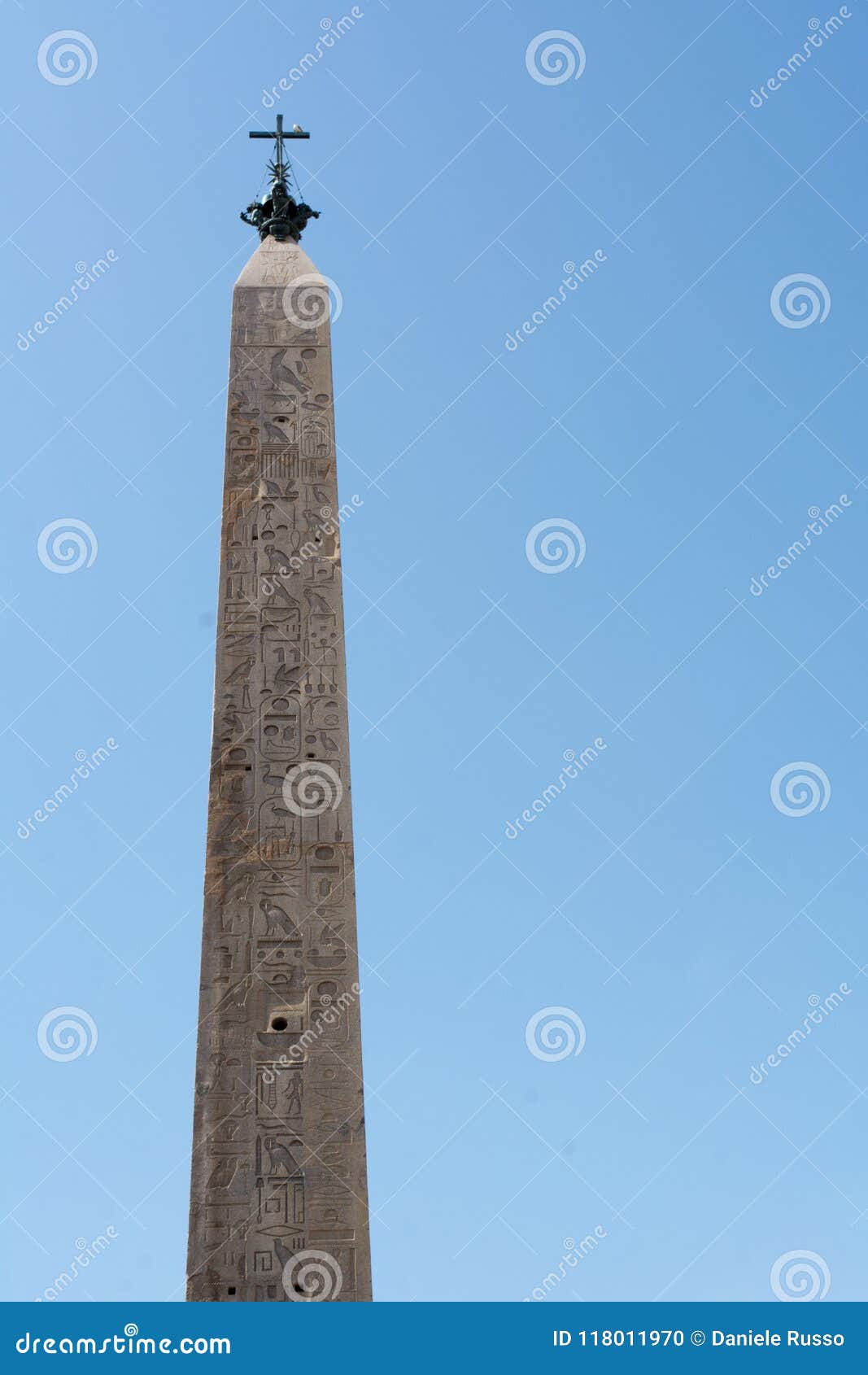 vertical view of the lateranense obelisk on blue sky background.