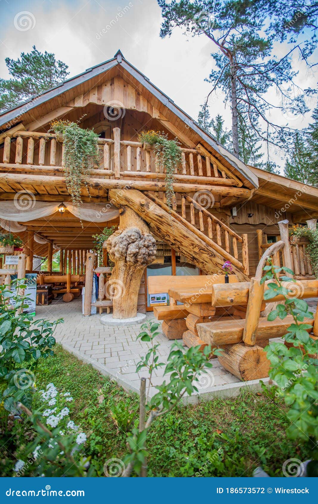 vertical view of a log cabin at hija glamping lake bloke in nova vas, slovenia