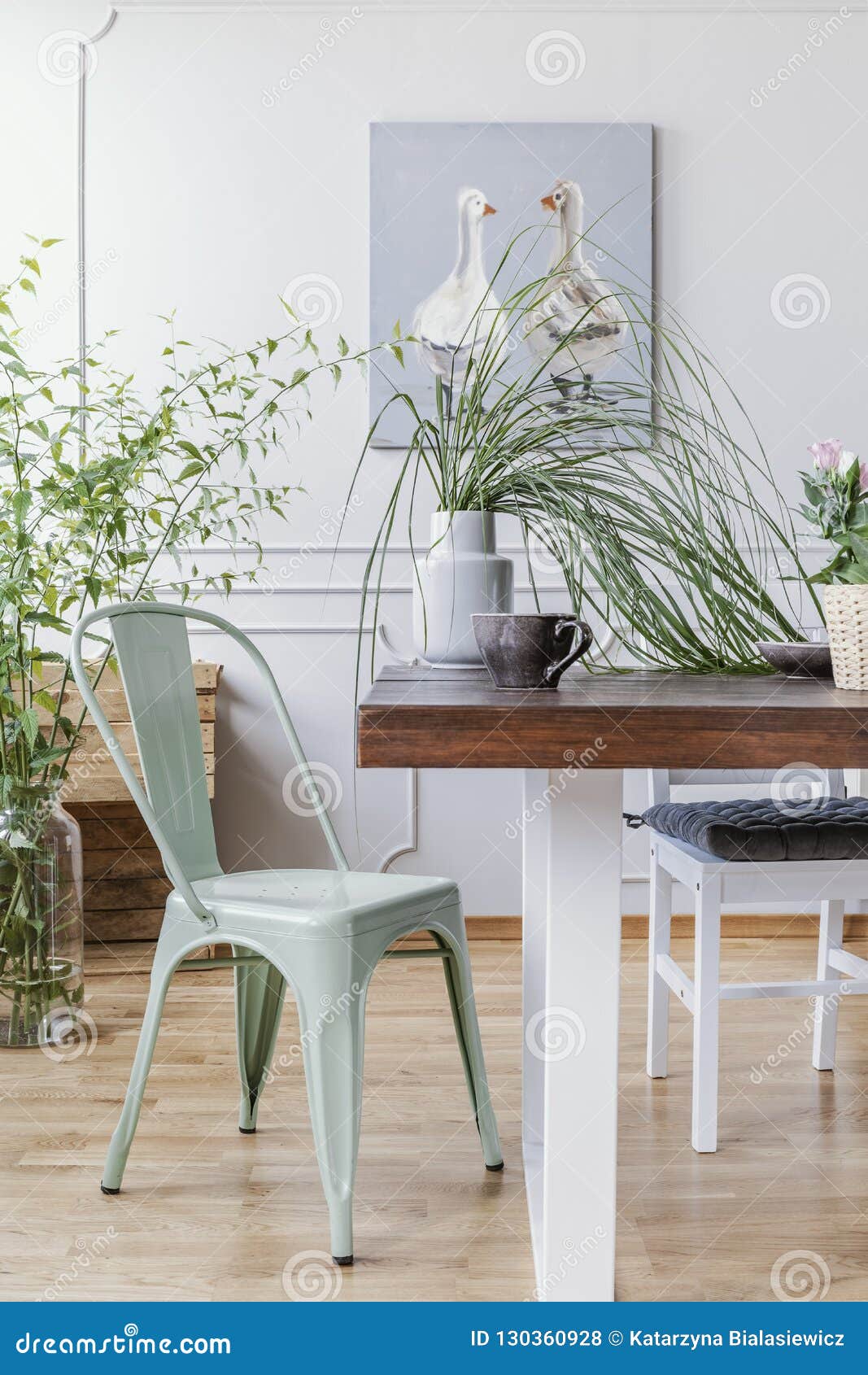 Vertical View Of Mint Green Chair Next To Wooden Table With