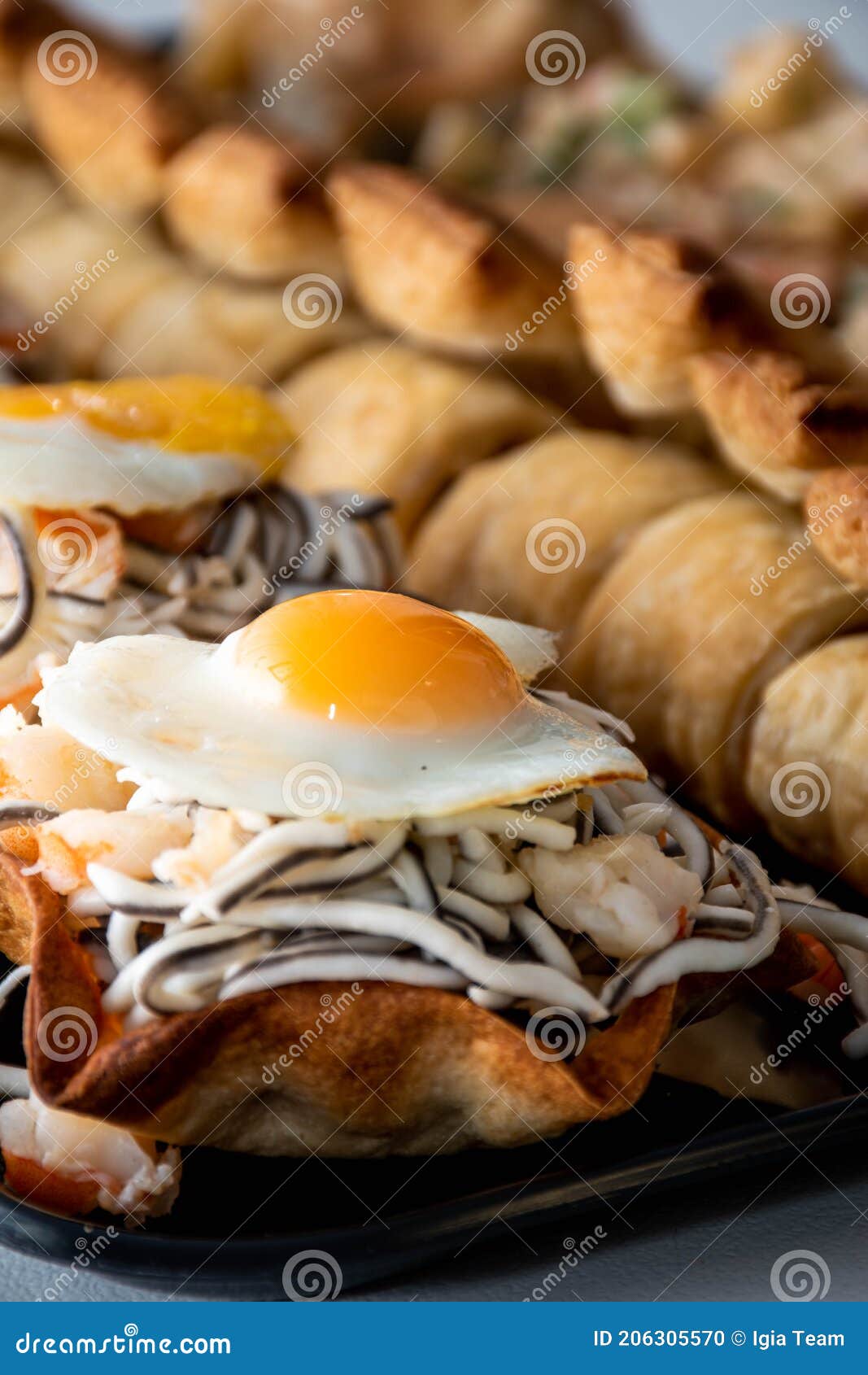 Vertical View of Puff Pastry with Gluttony, Quail Egg and Prawns 