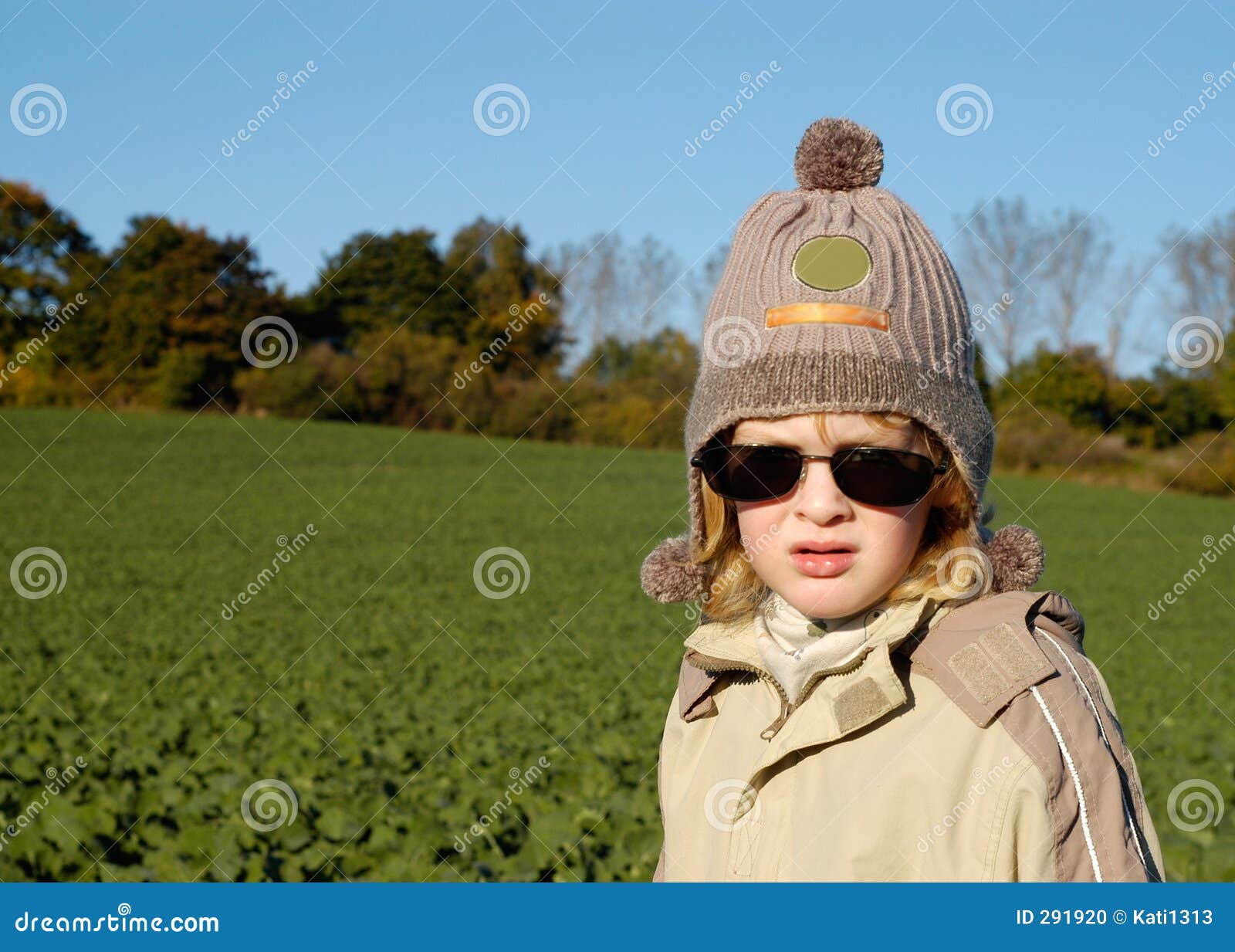 Verticale extérieure. Petit garçon avec des lunettes de soleil