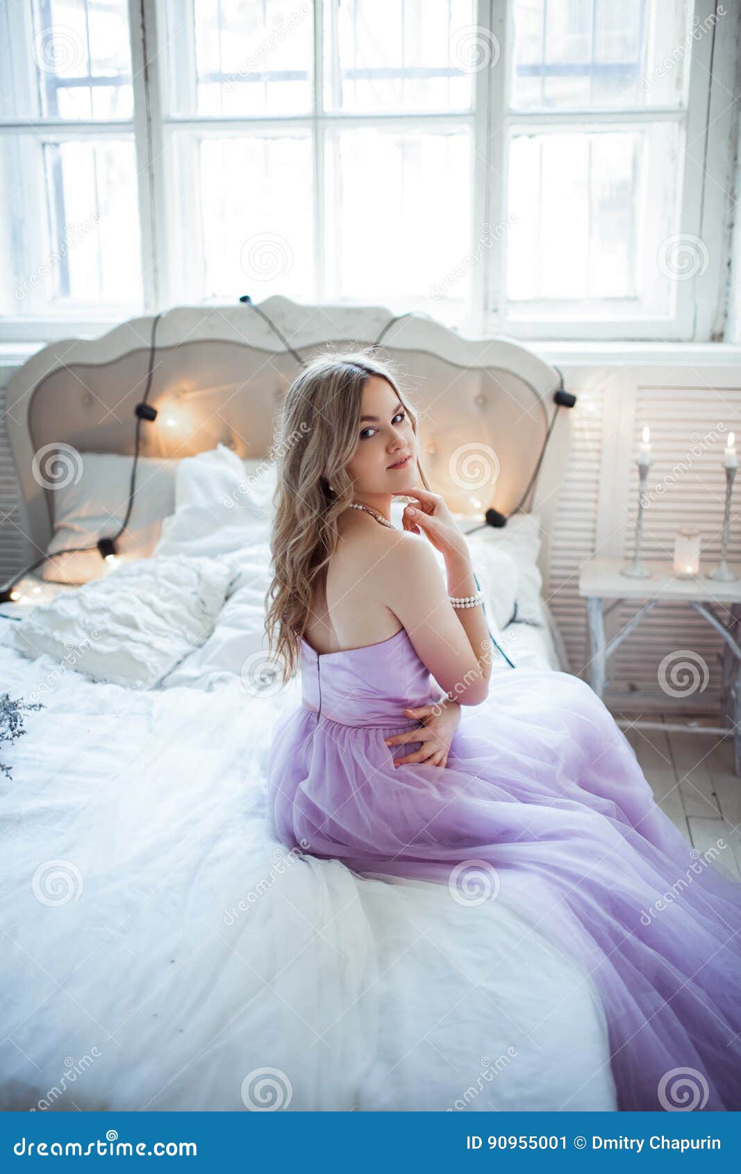 Very Beautiful Bride In A Delicate Purple Dress Sitting On