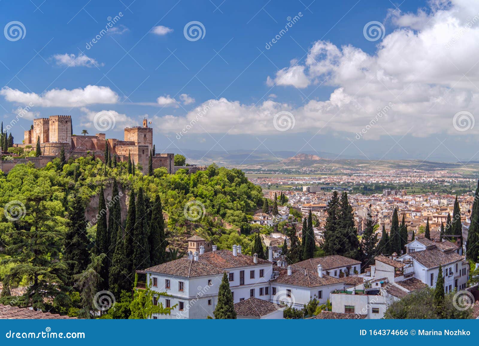 very beautiful view of alhambra, sacromonte and the city of granada with bright blue sky and white nubes