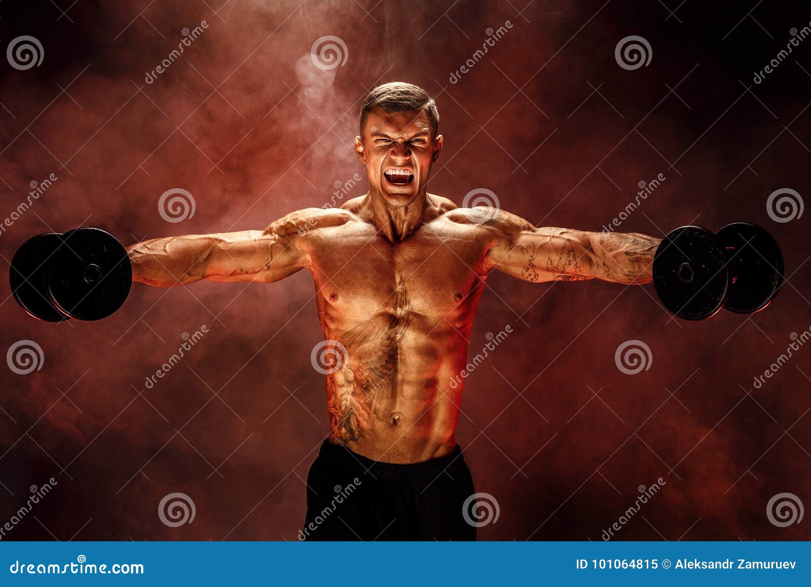 very brawny guy bodybuilder, execute exercise with dumbbells, on deltoid muscle shoulder