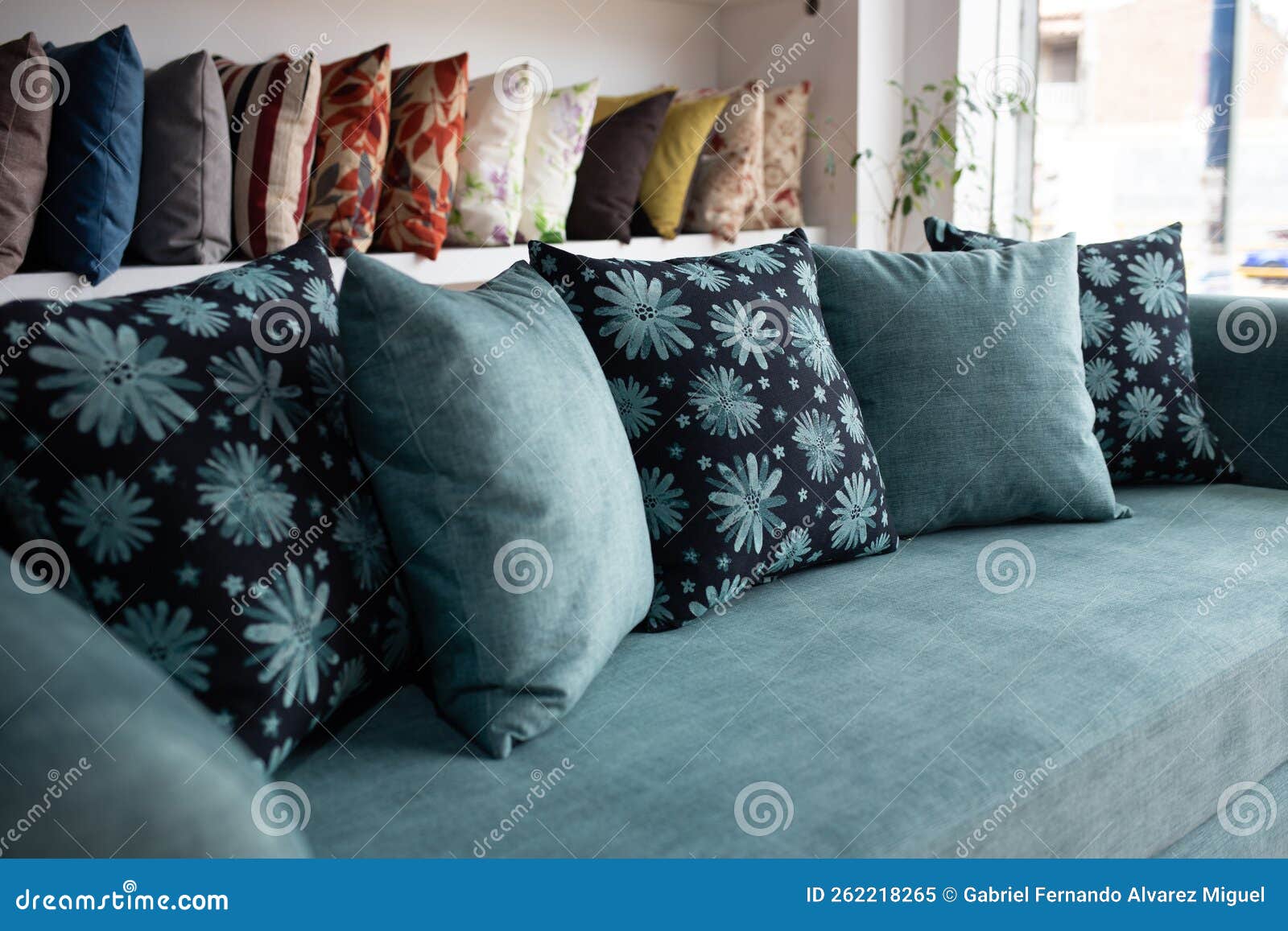 Very Comfortable Sofa in Front of a Wall with Cushions with Different