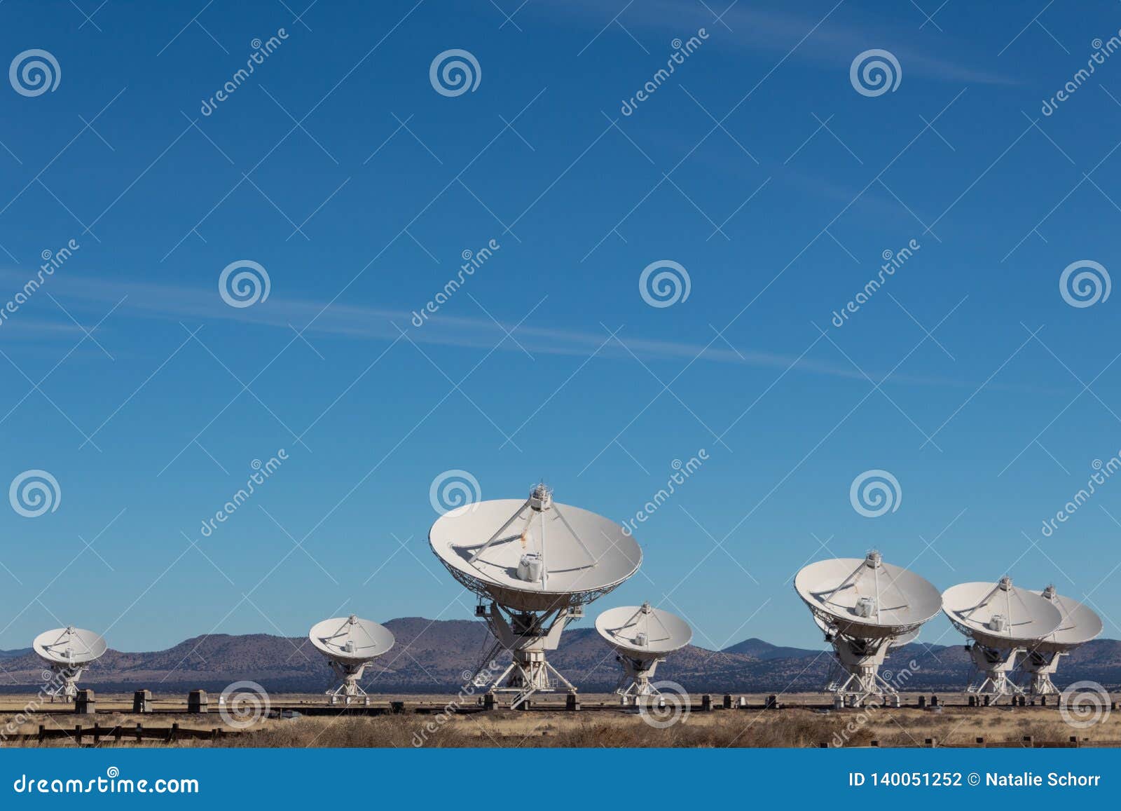 very large array grouping of radio antenna dishes in new mexico desert, blue sky