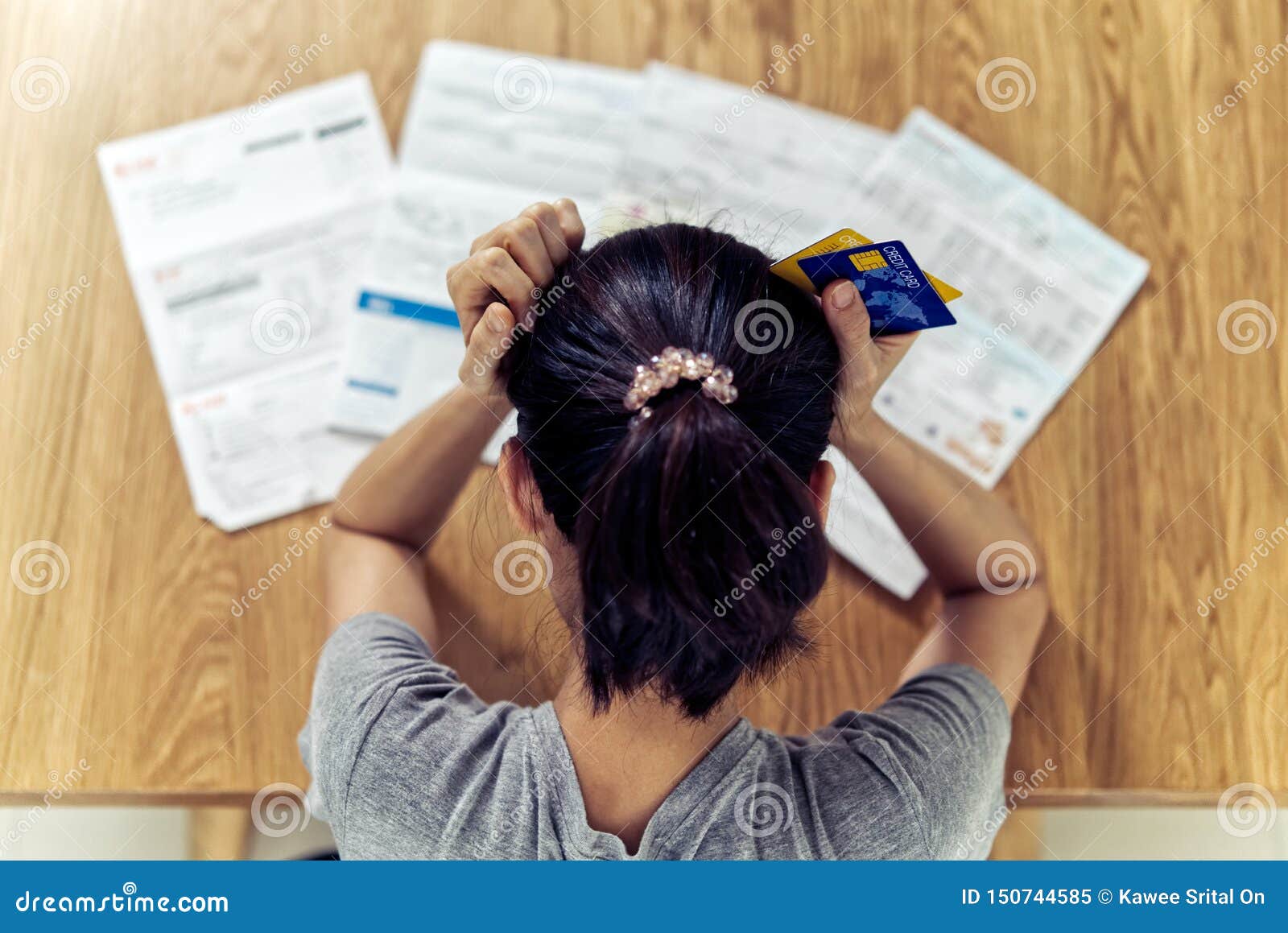 very stressed young sitting asian woman hands holding the head worry about find money to pay credit card debt.