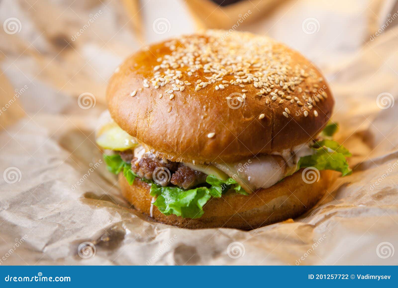 Very Ugly Cheeseburger with Bacon on Baking Paper Stock Photo Image