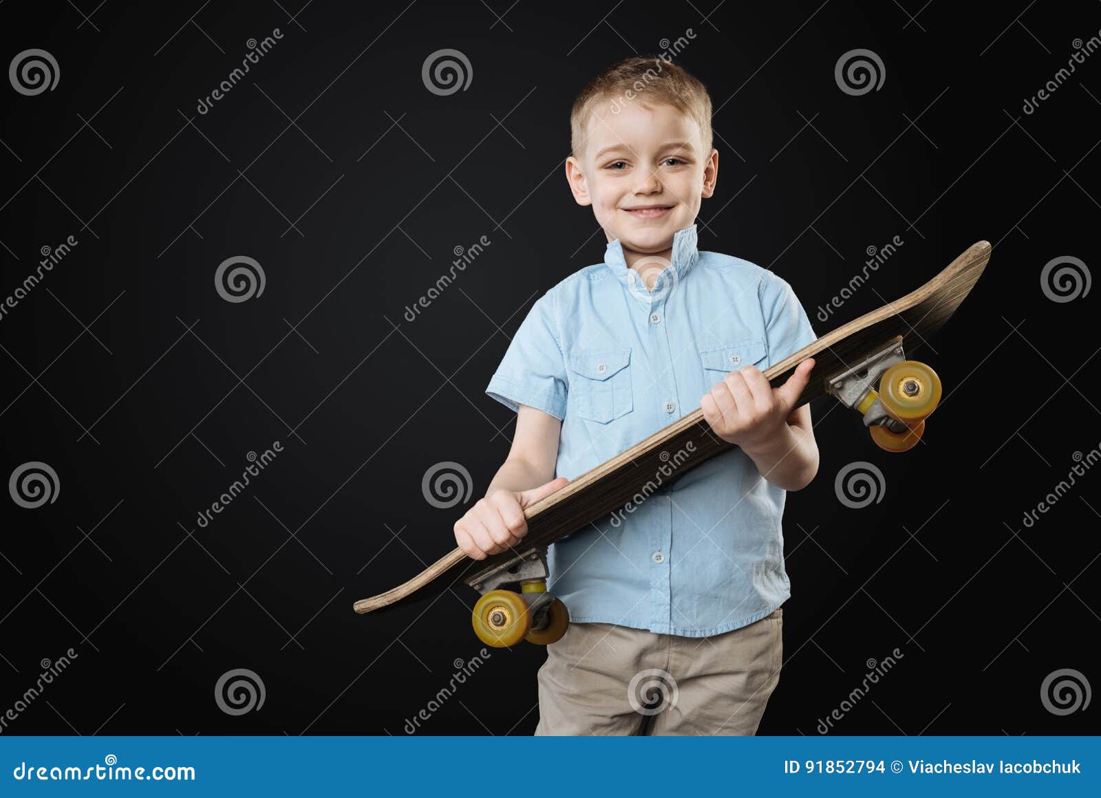 Very Young Sportsmen Holding Skateboard in Both Hands Stock Photo ...