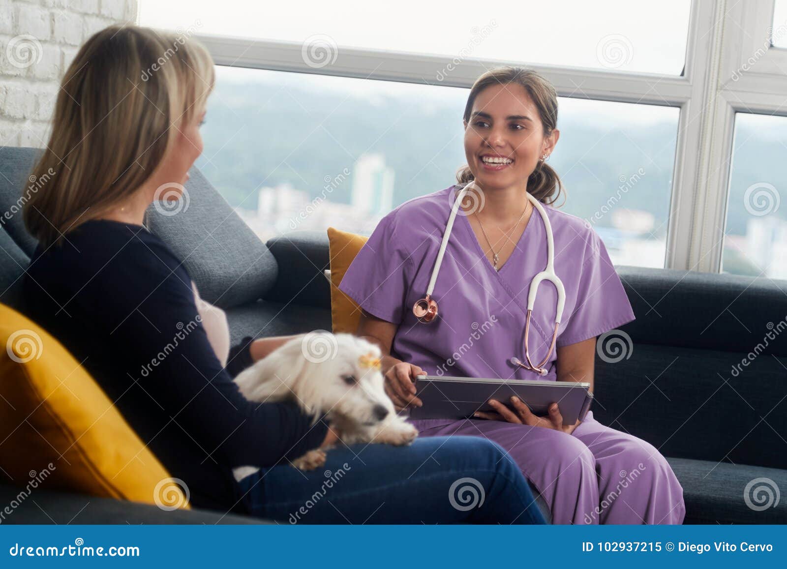 Dog Owner And Pet During Home Visit 