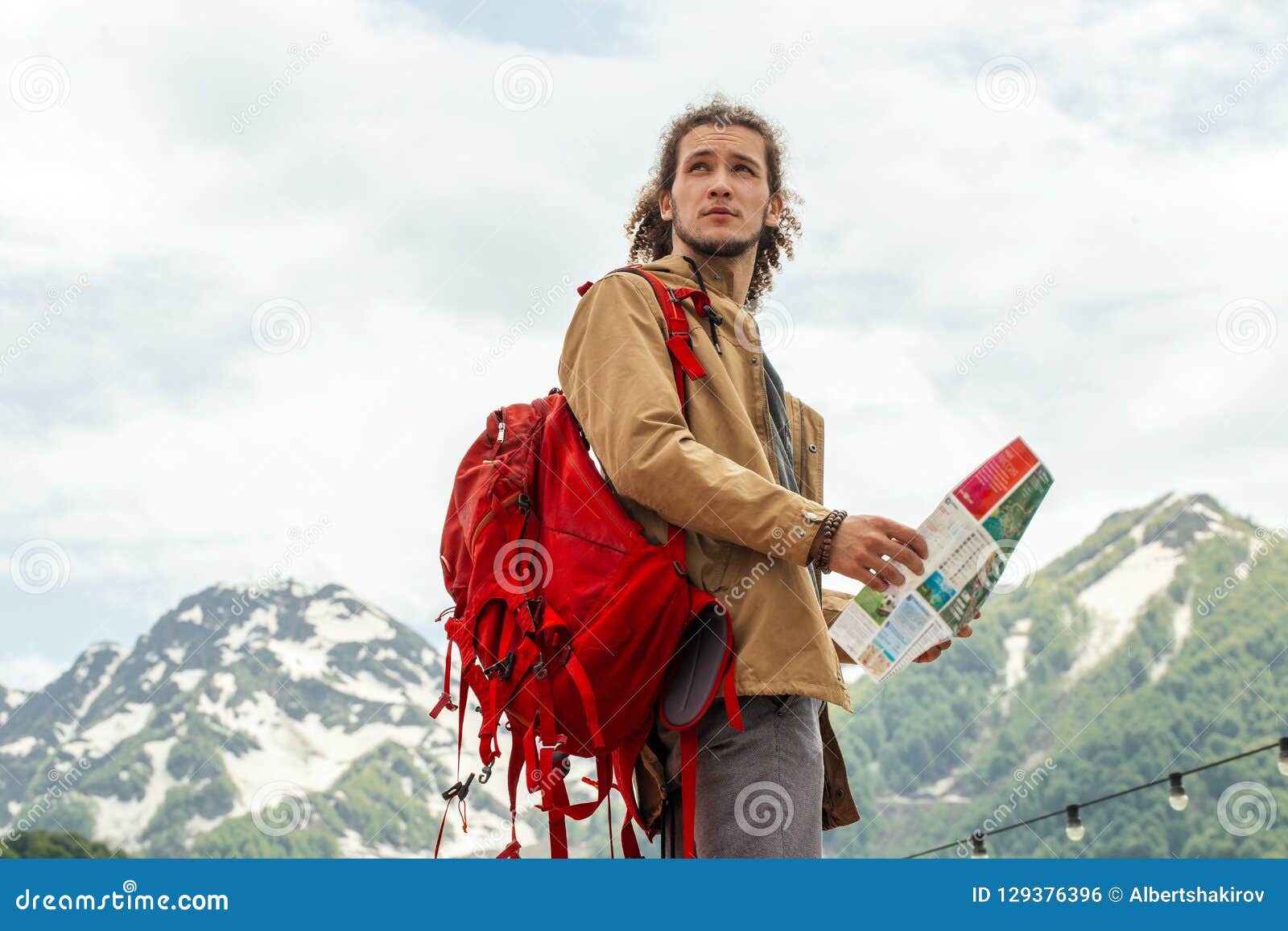 Del Hombre Con El Mapa La Mochila Roja Que Buscan La Ubicación Al Aire Libre Con Las Montañas Rocosas En Fondo Foto de archivo - Imagen de petate, extremo: 129376396
