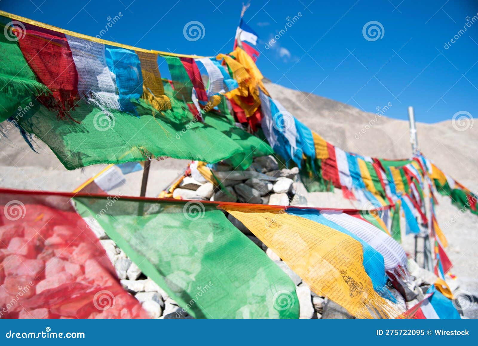 Vibrant Display of Prayer Flags Set Against a Backdrop of Rocks Stock