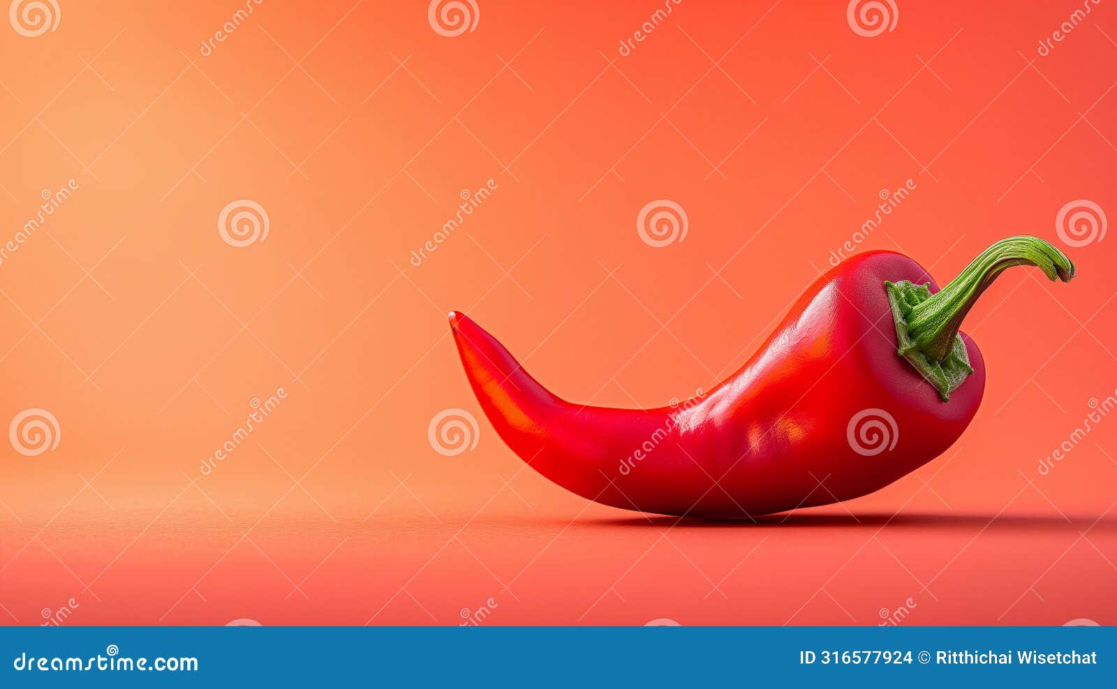 vibrant red chili pepper on a matching red background, positioned dynamically with a curved tail