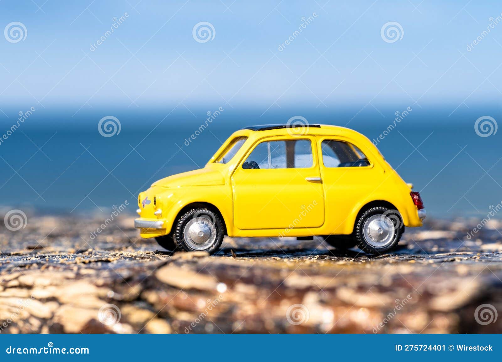 Vibrant Yellow Toy Car Parked on a Beach. Stock Image Image of