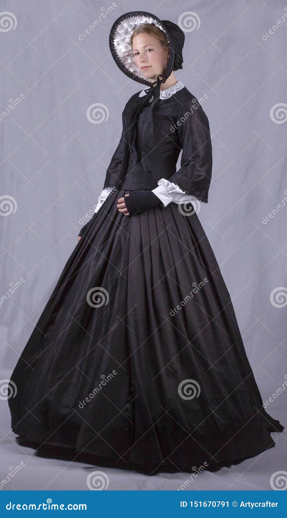 victorian woman in black bodice. bonnet and skirt