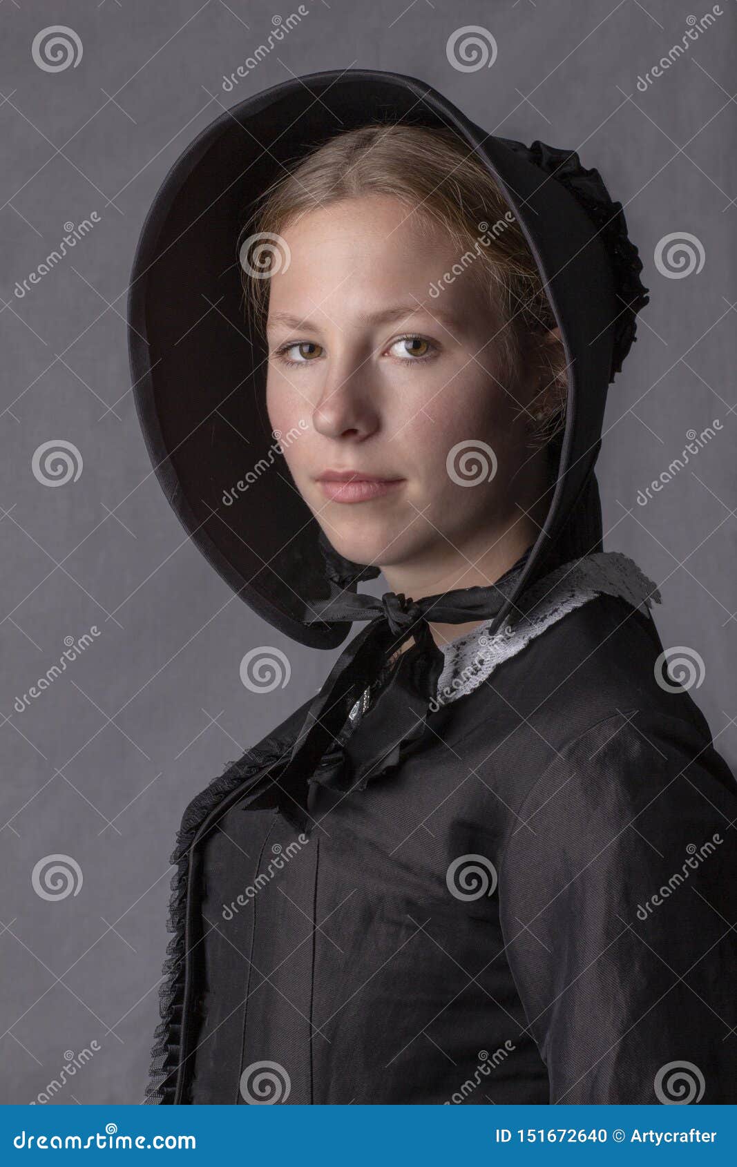 victorian woman in a black bodice and bonnet