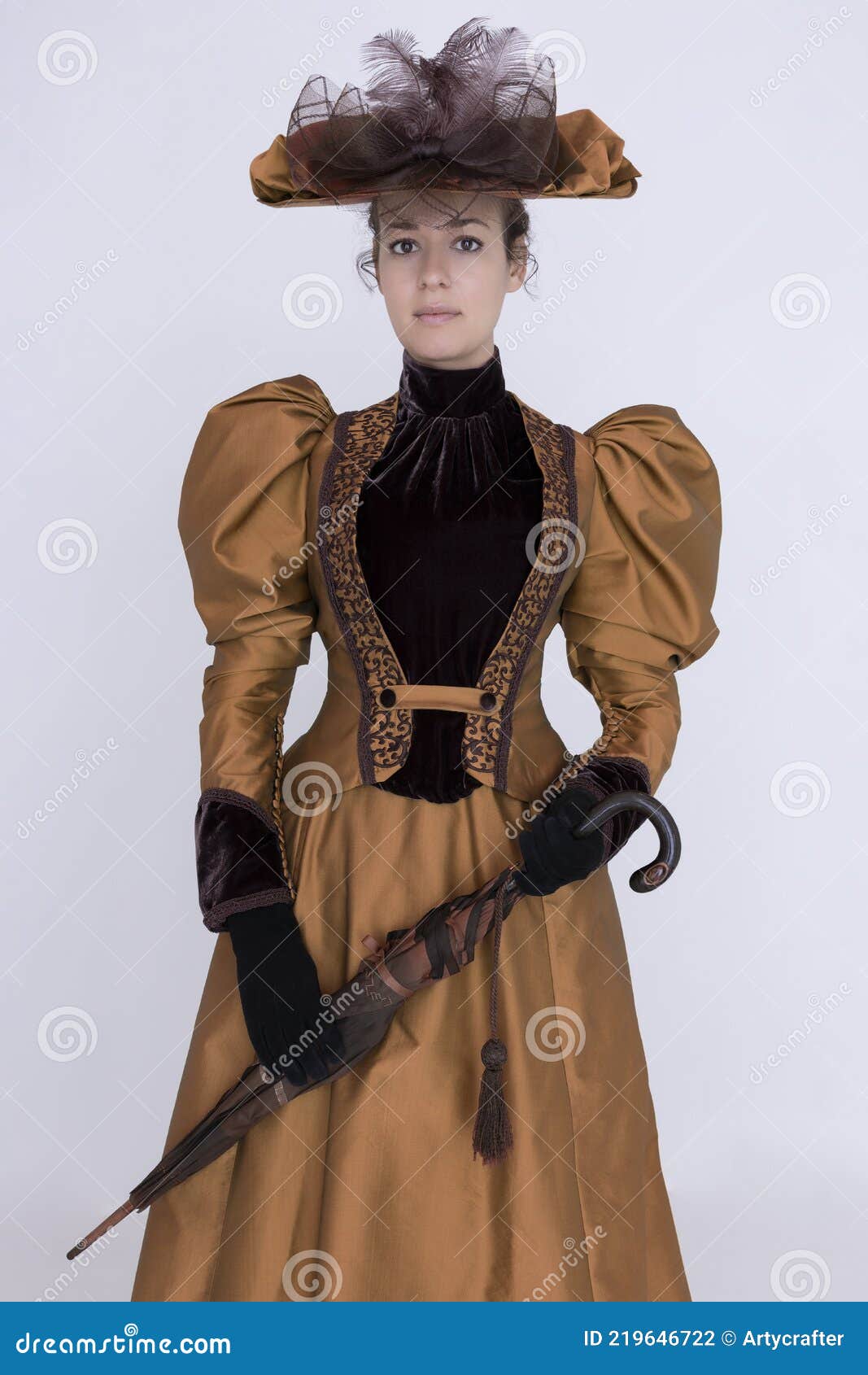 a victorian woman wearing a bronze and brown silk ensemble