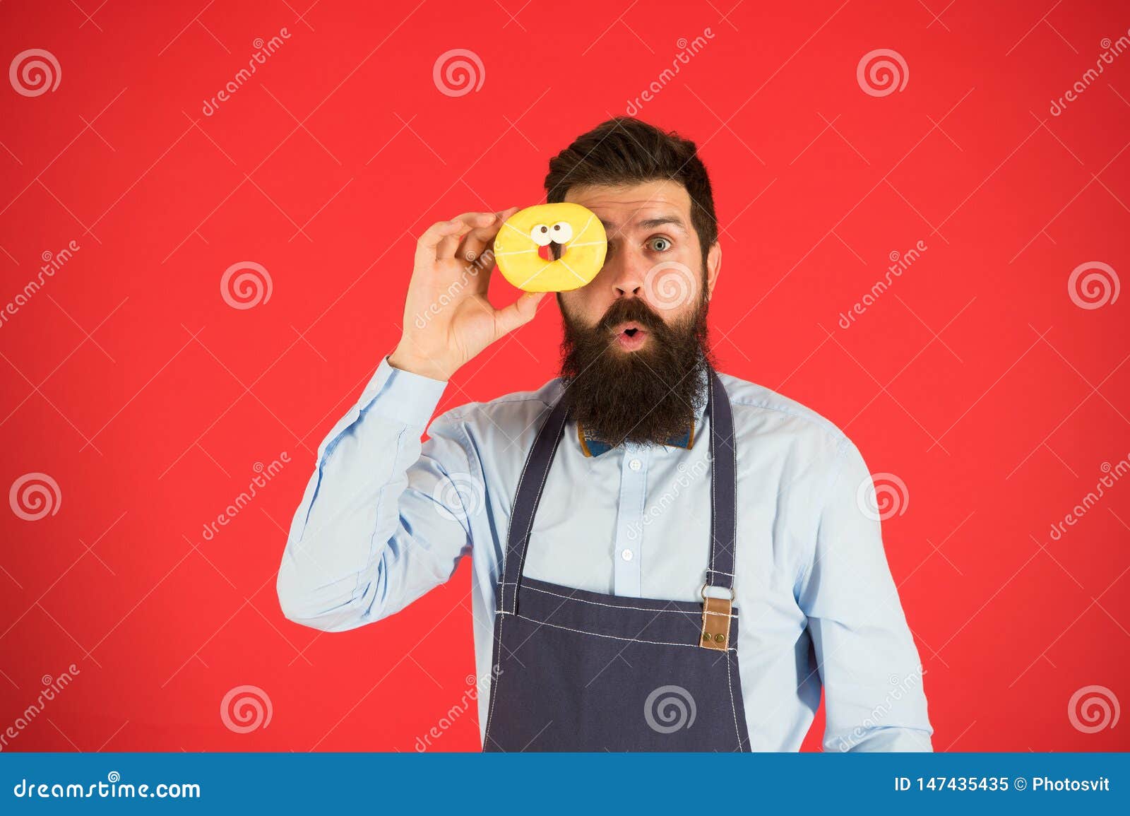 Sweet life. Bearded man in apron. Diet and healthy food. Doughnut diet. Calorie. Feel hunger. No diet. Chef man in cafe. baker hold donut. Funny hipster. Male deit. Cafe service. Food choices.