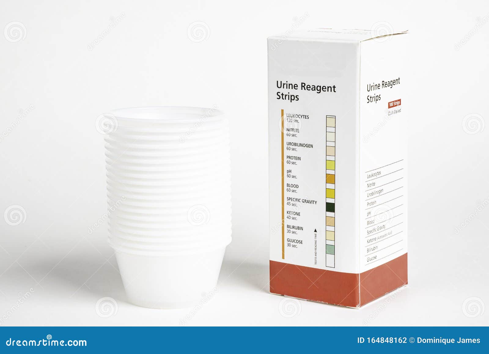 Urine Strips Box and a Stack of Plastic Containers Editorial