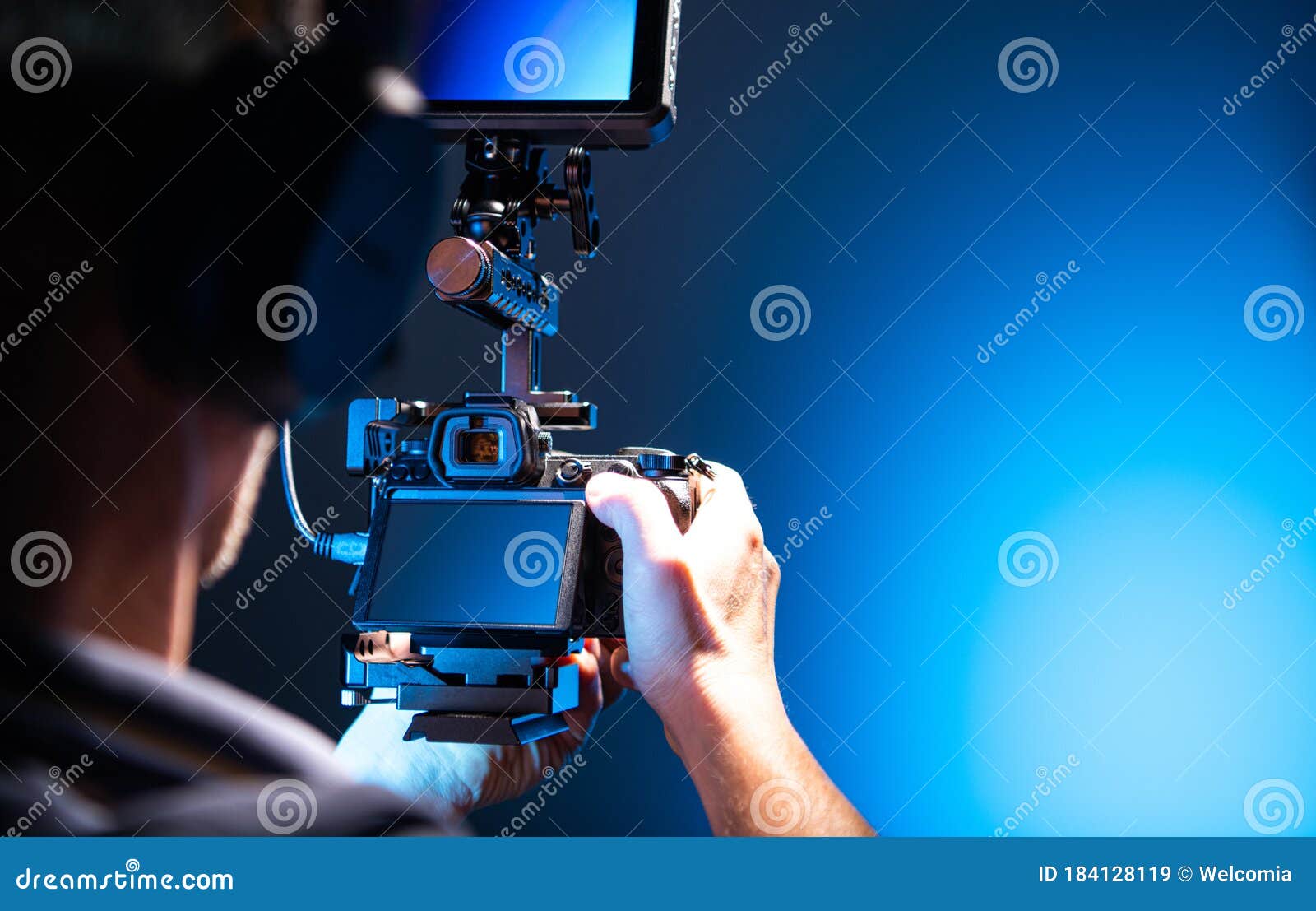 video operator with modern dlsr camera in hands