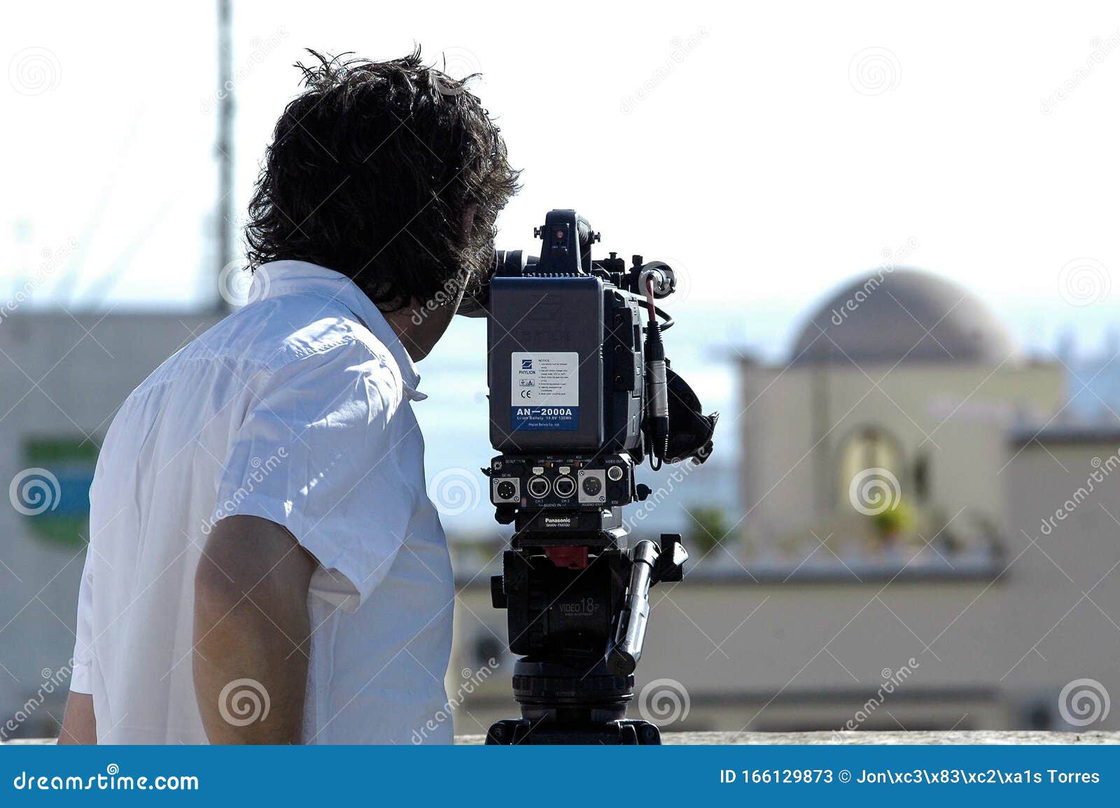 Videographer with Tripod Camera in Documentary Film Shooting Editorial