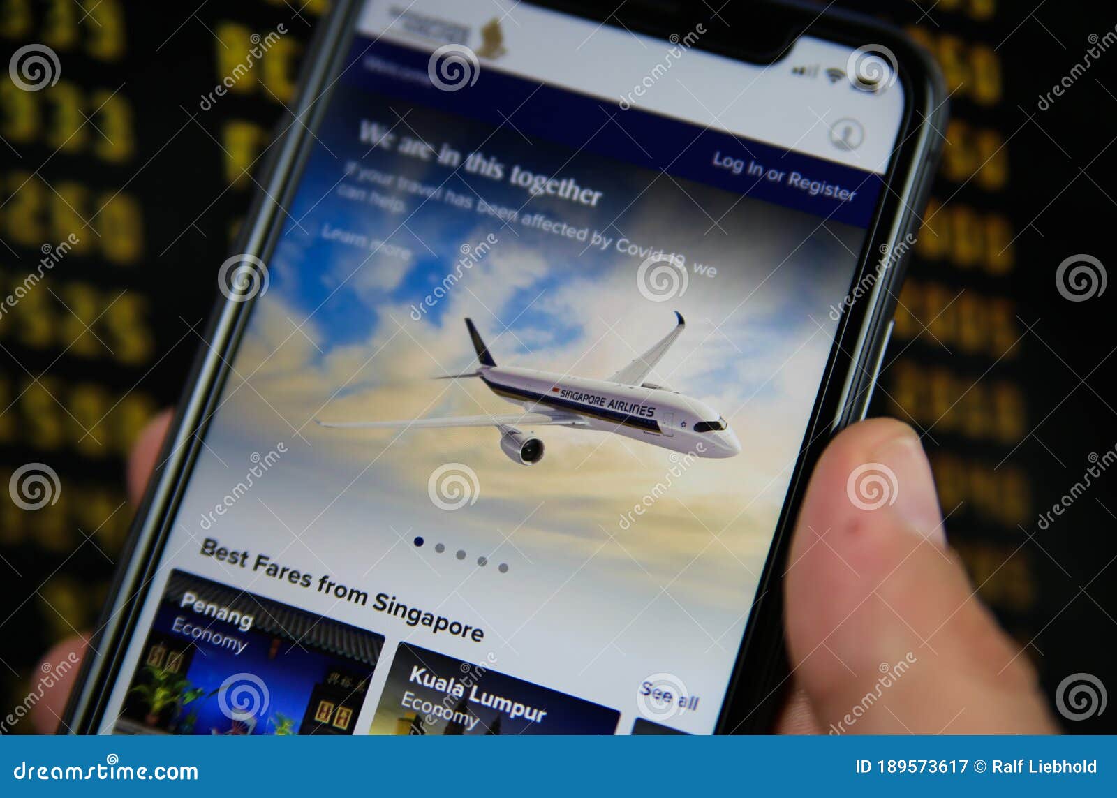 Closeup Of Mobile Phone With Singapore Airlines Flight Booking App Blurred Departure Board Background Editorial Photography Image Of Airline Isolated 189573617